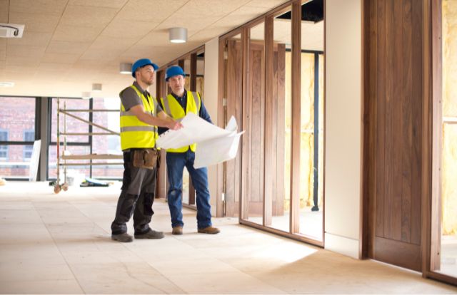 Office Refurbishments For Landlords - Landlord Reviewing Project Plans With Project Manager